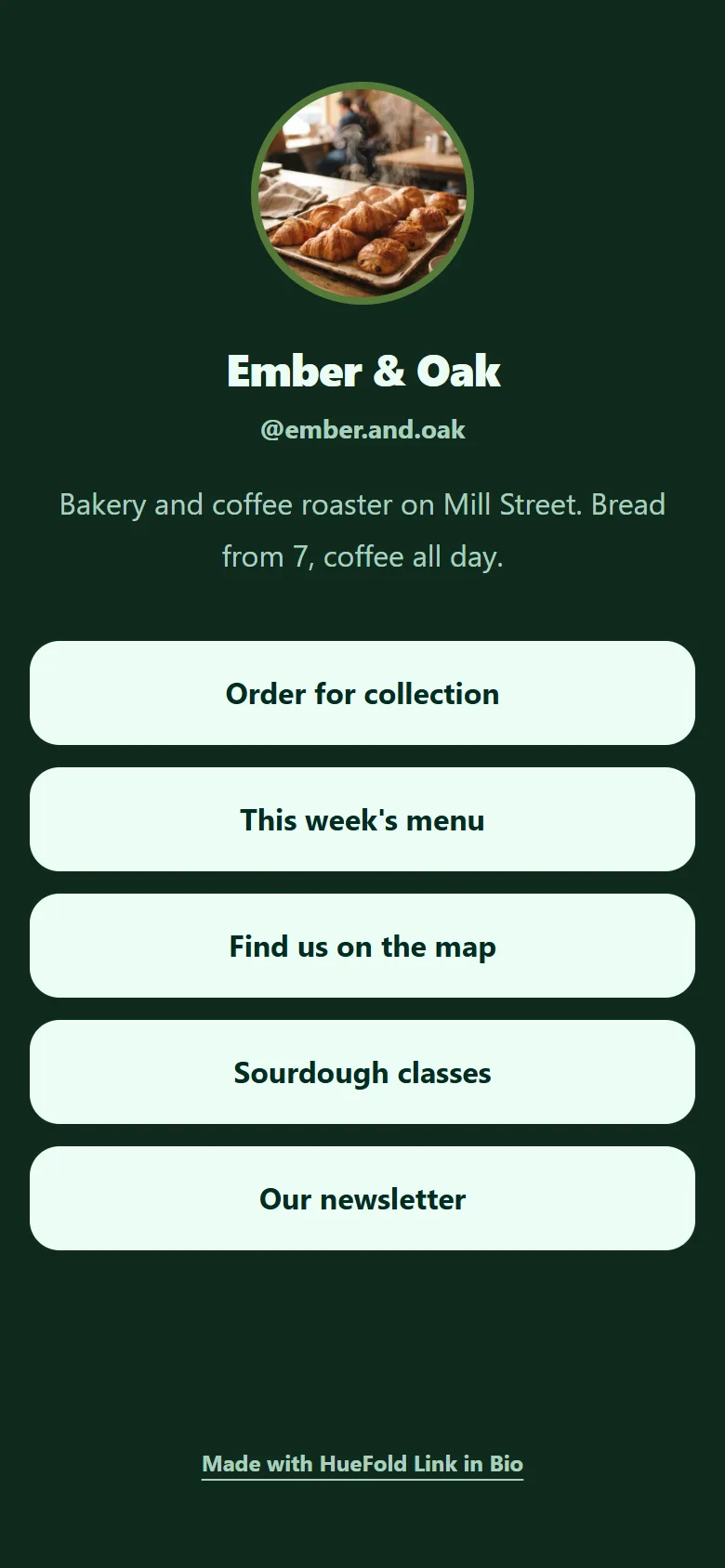 The published Ember & Oak page on a phone: a round photo of croissants with a green ring, Ember & Oak, @ember.and.oak, Bakery and coffee roaster on Mill Street. Bread from 7, coffee all day, and five pale buttons from Order for collection to Our newsletter