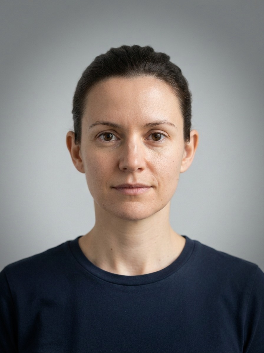 A studio portrait with a dark vignette, as downloaded
